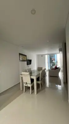 a living room with a table and chairs and a couch at Amplio y hermoso apartamento para disfrutar in Barranquilla
