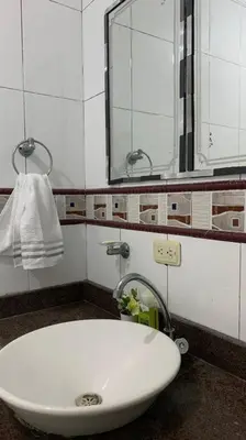 a bathroom with a white sink and a mirror at Cómodo apartamento para hospedaje in Cartagena de Indias