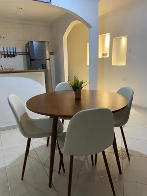 a wooden table and chairs in a kitchen at Cómodo apartamento para hospedaje in Cartagena de Indias