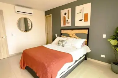 a bedroom with a bed with an orange blanket at Luxury View, 3 Rooms in Cartagena de Indias