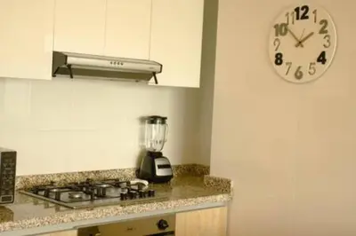a kitchen with a clock on the wall and a counter at Luxury View, 3 Rooms in Cartagena de Indias