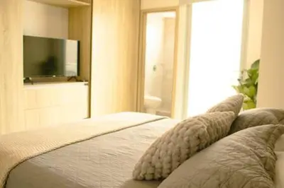 a bedroom with a bed with pillows and a television at Luxury View, 3 Rooms in Cartagena de Indias