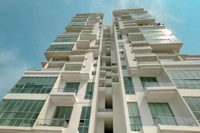 a tall white building with green windows at Luxury View, 3 Rooms in Cartagena de Indias