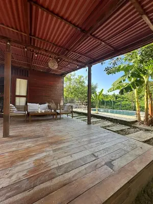 an outdoor deck with a pergola at Cabaña Privada con Piscina y Aire Acondicionado in Isla Fuerte