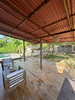 a wooden patio with a wooden pergola at Cabaña Privada con Piscina y Aire Acondicionado in Isla Fuerte