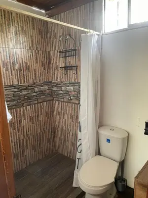 a bathroom with a toilet and a shower at Cabaña Privada con Piscina y Aire Acondicionado in Isla Fuerte