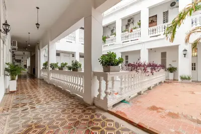 a corridor of a white building with potted plants at Loft en Corazón de Ciudad Antigua in Cartagena de Indias