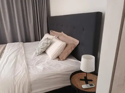 a bedroom with a bed with pillows and a table at Apartamento en Pozos Colorados Santa Marta Suite 1309 -Pozos Colorados in Santa Marta