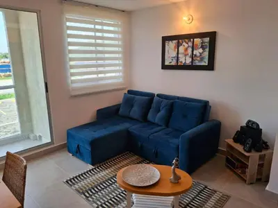a living room with a blue couch and a table at Apartamento Cartagena cerca a la playa in Cartagena de Indias