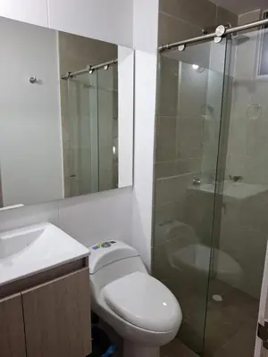 a bathroom with a toilet and a glass shower at Apartamento Cartagena cerca a la playa in Cartagena de Indias