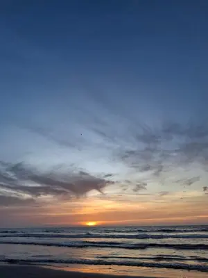 a sunset on a beach with the ocean at Apartamento Cartagena cerca a la playa in Cartagena de Indias
