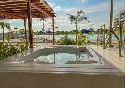 a jacuzzi tub with a view of the beach at Apartamento 4g Baia Kristal Cartagena in Cartagena de Indias