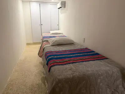 two beds in a small room with a bedskirts at Apartamento en Las Bovedas in Cartagena de Indias