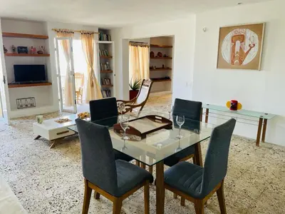a living room with a glass table and chairs at Apartamento en Las Bovedas in Cartagena de Indias