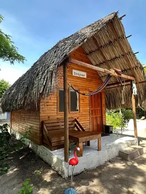 a wooden hut with a bench in front of it at Palma Plata islas del Rosario in Isla Grande