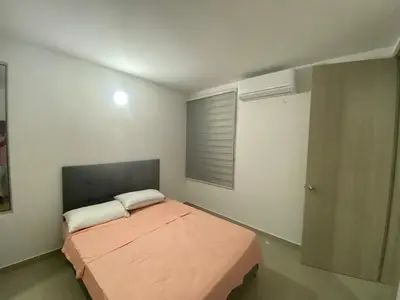 a bedroom with a large bed with a window at Apartamento Amoblado en Cartagena in Cartagena de Indias