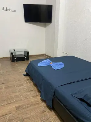 a room with a bed and a flat screen tv at Hotel Corales del Mar in Cartagena de Indias
