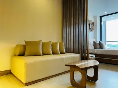 a living room with a couch and a bed and a stool at Exclusivo loft - frente al mar in Cartagena de Indias