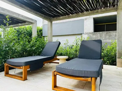 two chairs and a ottoman sitting on a patio at Exclusivo loft - frente al mar in Cartagena de Indias