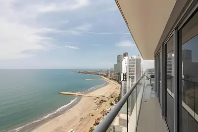 a view of the beach from the balcony of a building at Awesome Sea View and Historic Center “Morros City” in Cartagena de Indias