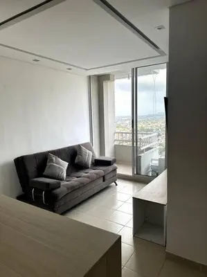 a living room with a couch and a large window at Luminoso y confortable in Cartagena de Indias