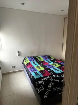 a bedroom with a bed with a quilt on it at Luminoso y confortable in Cartagena de Indias