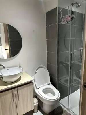 a bathroom with a toilet and a sink and a shower at Luminoso y confortable in Cartagena de Indias