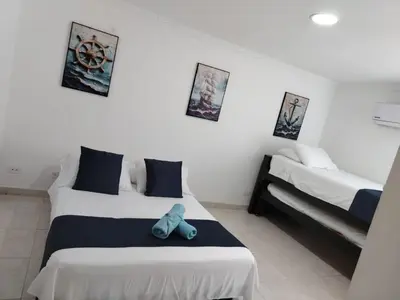 a bedroom with two beds and a blue stuffed animal on the bed at Balcón del mar in Cartagena de Indias