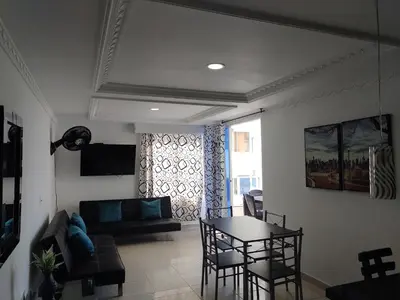 a living room with a table and a couch at Balcón del mar in Cartagena de Indias