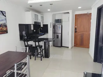 a kitchen with a table and a refrigerator at Balcón del mar in Cartagena de Indias