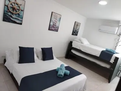 a room with two beds with a stuffed elephant on the bed at Balcón del mar in Cartagena de Indias