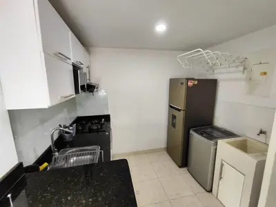 a small kitchen with a sink and a refrigerator at EM3-1G APARTAMENTO DE 1 HAB EN ZONA RESIDENCIAL AIRE ACONDICIONADO Wifi Y PARQUEADERO in Cartagena de Indias