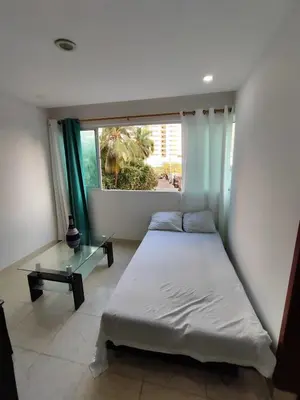 a bedroom with a bed and a glass table at EM3-1G APARTAMENTO DE 1 HAB EN ZONA RESIDENCIAL AIRE ACONDICIONADO Wifi Y PARQUEADERO in Cartagena de Indias