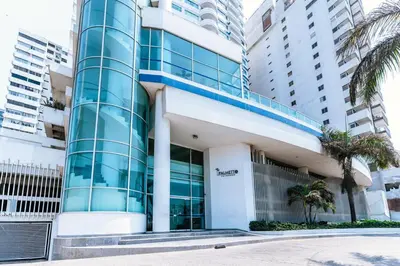 an office building with palm trees in front of it at Cartagena Paradise Beach Home Sleeps 7 in Cartagena de Indias