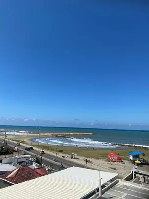 a view of a beach with a red truck at Apartamento con vista al mar Cartagena piscina in Cartagena de Indias