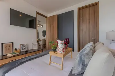 a bedroom with a bed with a tv on the wall at Stunning Sea View and Historic Center 20th FL/ 2BR in Cartagena de Indias