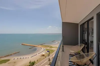 a view of the beach from the balcony of a hotel at Stunning Sea View and Historic Center 20th FL/ 2BR in Cartagena de Indias
