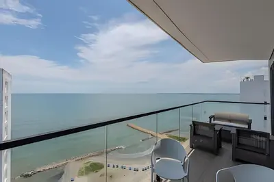 a balcony with chairs and a view of the ocean at Espectacular Vista al Mar and Historic Center 2BR in Cartagena de Indias