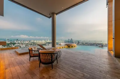 a balcony with chairs and a view of the city at Espectacular Vista al Mar and Historic Center 2BR in Cartagena de Indias