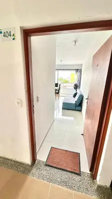 a hallway with a door open to a living room at Apartamento amoblado cerca al mar in Cartagena de Indias
