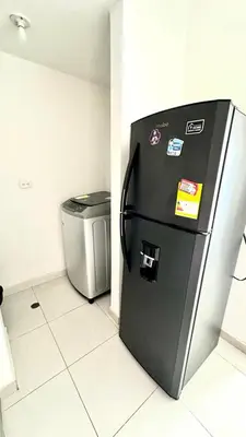 a refrigerator and a trash can in a room at Apartamento amoblado cerca al mar in Cartagena de Indias