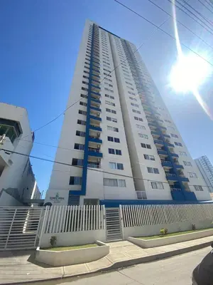a tall white building with the sun behind it at Apartamento amoblado cerca al mar in Cartagena de Indias