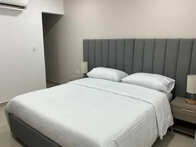a bedroom with a large white bed with two pillows at Hotel fenix in Barranquilla