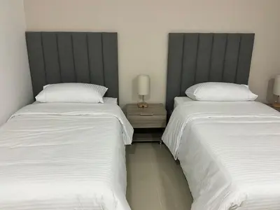 two beds sitting next to each other in a bedroom at Hotel fenix in Barranquilla