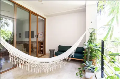 a hammock in the living room of a house at Cozy New Apartment in the Old City in Cartagena de Indias