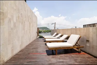 a row of chaise lounge chairs on a wall at Cozy New Apartment in the Old City in Cartagena de Indias