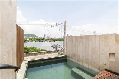 a swimming pool with a view of the water at Cozy New Apartment in the Old City in Cartagena de Indias