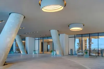 a lobby with columns and tables in a building at Exclusive Sea View “Morros City” 30th Fl in Cartagena de Indias