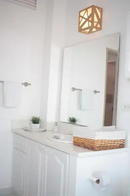 a bathroom with a white sink and a mirror at HERMOSOS APARTAMENTOS EN La CIUDAD VIEJA in Cartagena de Indias