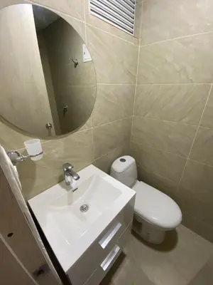 a bathroom with a sink and a toilet and a mirror at Apartamento LOFT INFINITY BLUE in Santa Marta